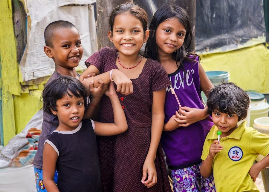 Children in a village smiling together